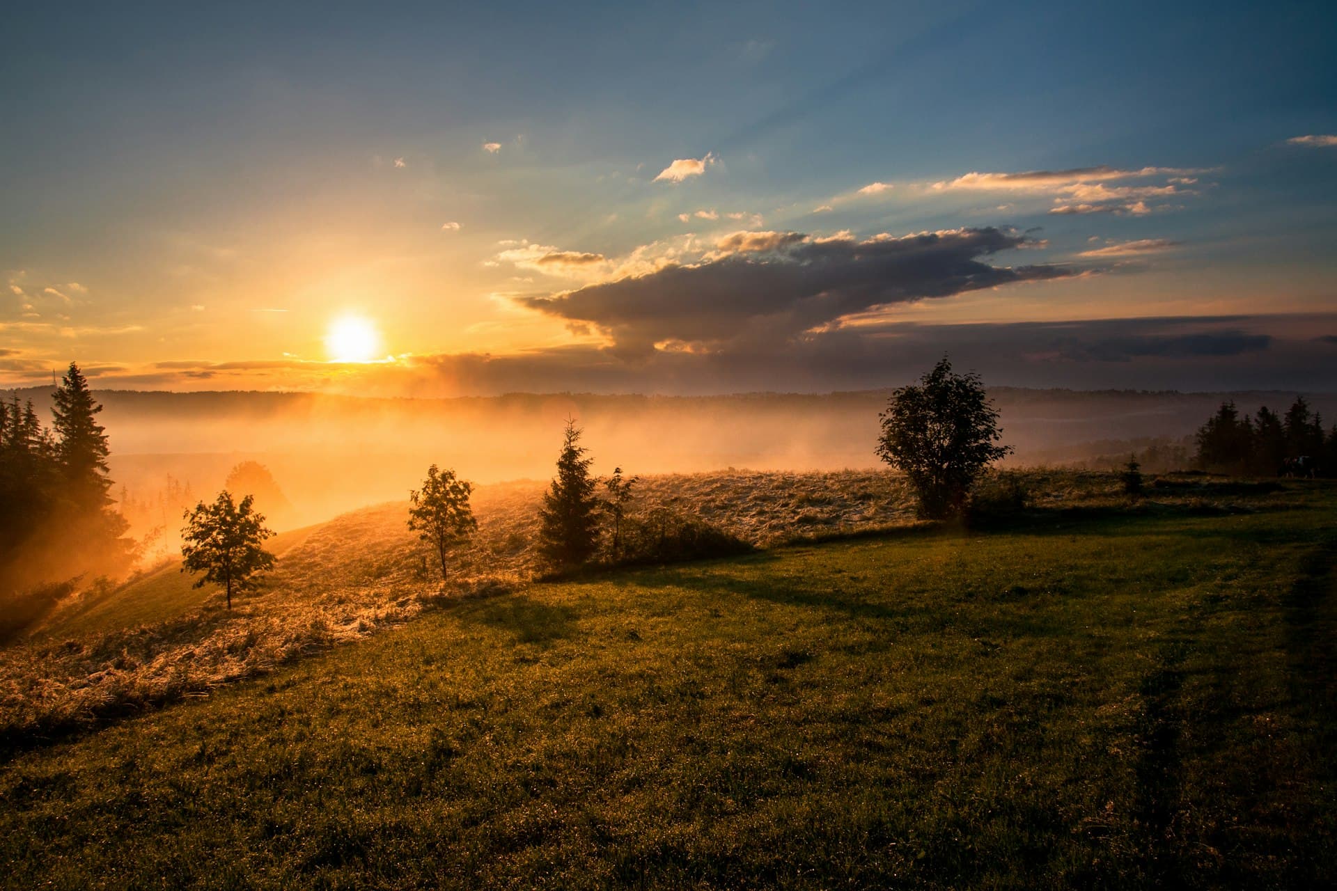 Morning mist over quiet hills at sunrise