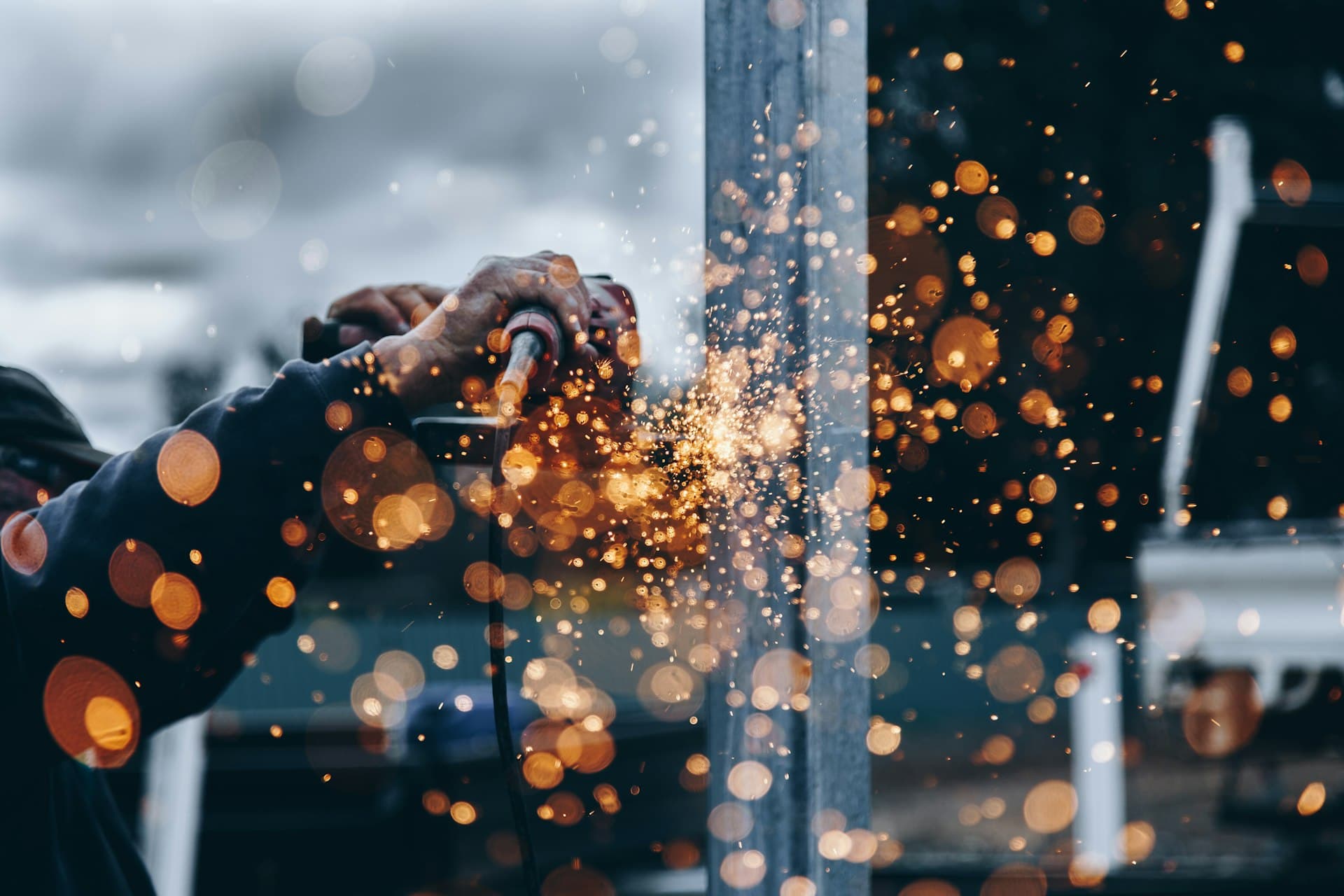 Sparks flying as a craftsman grinds steel — character being forged