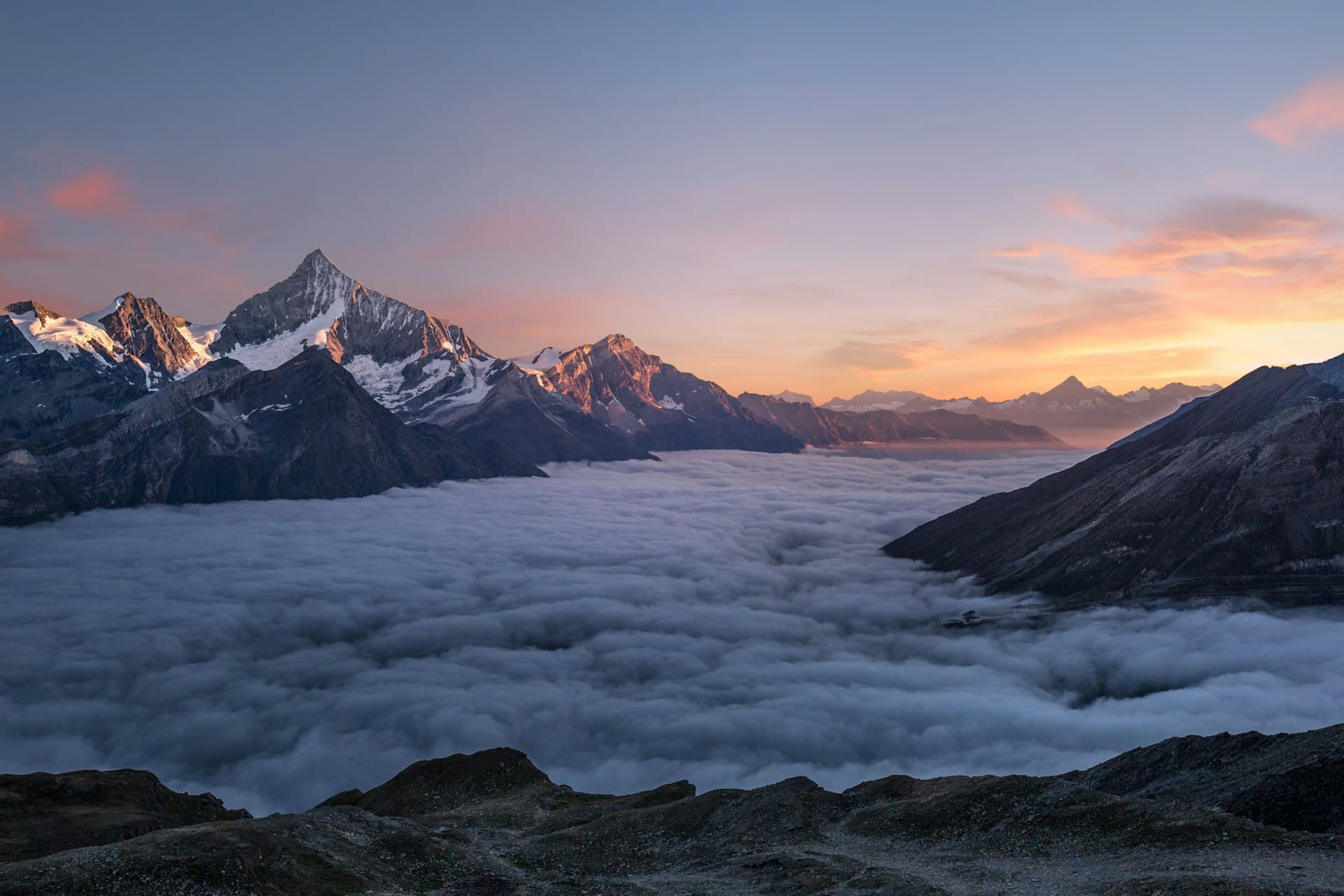 Snow-capped peaks above a sea of clouds